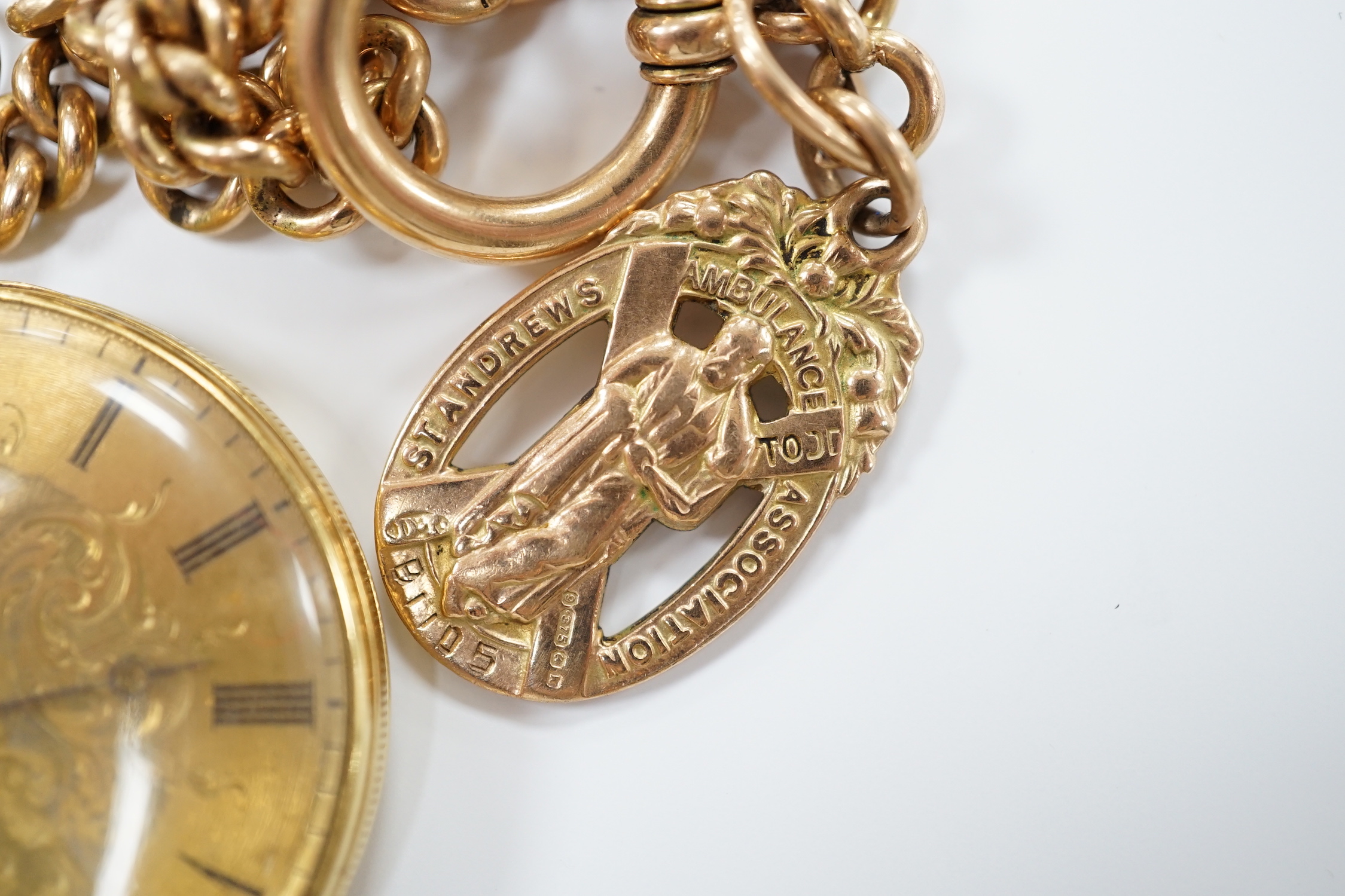 An 18k open face fob watch, with Roman dial, gross weight 38.5 grams, with key, together with a 9ct albert hung with a 9ct gold St. Andres Ambulance Association charm, gross weight 24.2 grams.